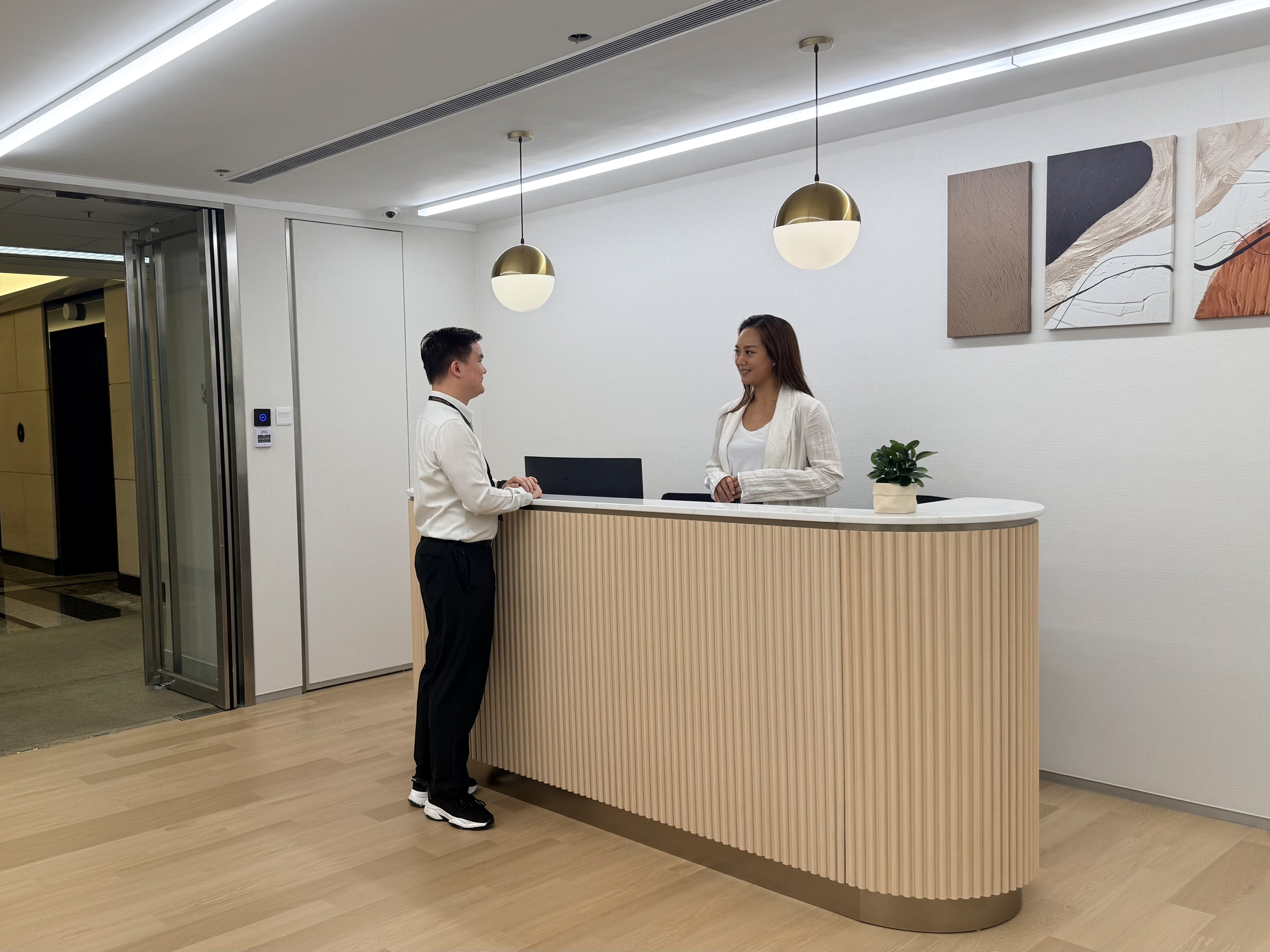 receptionist talking to client at reception admiralty office space