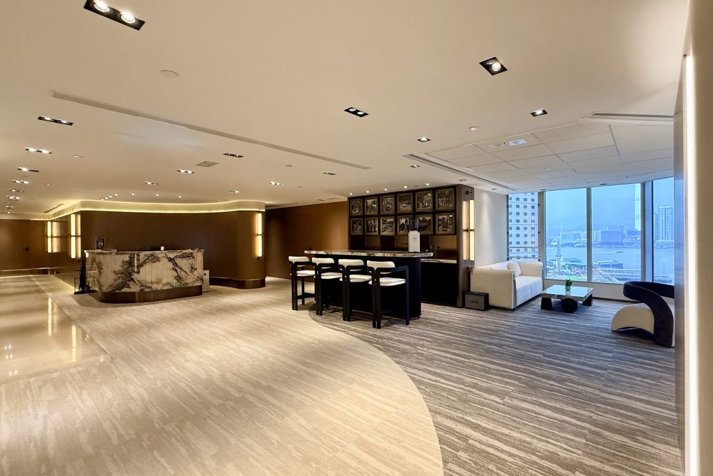 office lounge with high bar table and sofa and reception desk